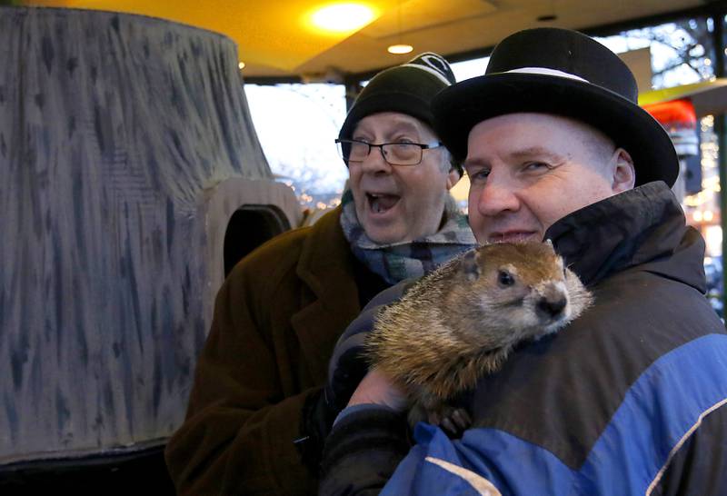 Stephen Tobolowsky who played "Ned Ryerson" in the movie "Groundhog Day" with  Woodstock Willie and his handler Mark Szafran on Sunday, Feb. 2, 2025, during the annual Groundhog Day Prognostication in the Woodstock Square.