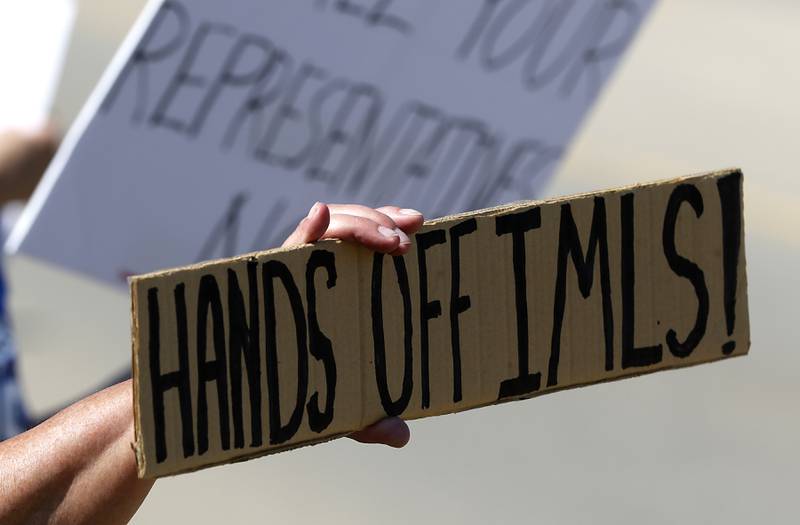 A protest sign on Friday, June 20, 2025, during a Save Our Libraries Protest hosted by Indivisible McHenry County to draw attention to cuts to the nation’s libraries by the Trump administration.