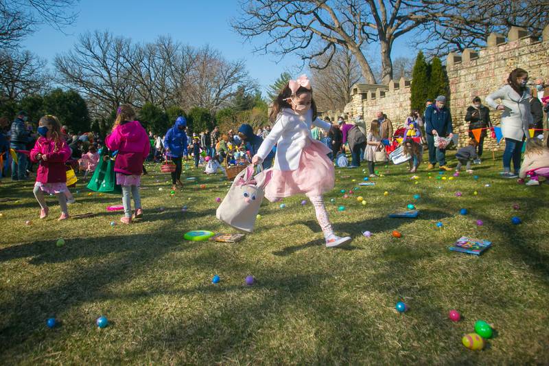 Jackie Rylko, 8, of Cary, runs towards eggs during the annual Easter egg hunt at Bettendorf Castle on Saturday, April 3, 2021, in Fox River Grove. The Easter egg hunt featured over 15,000 easter eggs hidden across the Bettendorf Castle grounds, with prizes including candy, toys and tickets to exchange for even larger prizes. Included in this year's festivities was a meet-and-greet with Disney princesses and the Easter Bunny.