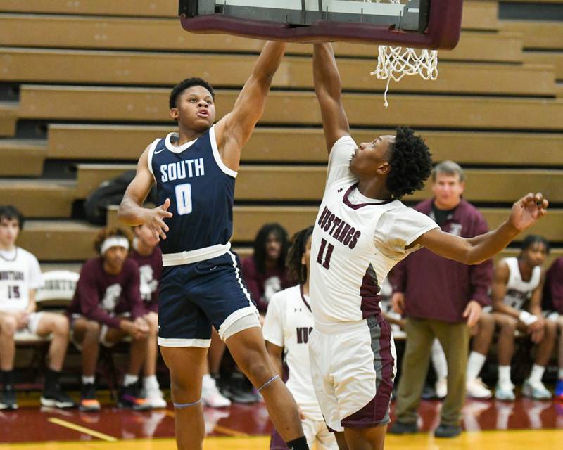 owners Grove South's Jalen House (0) goes up for a shot in the first quarter while being defended by Morton East's Tyler Nichols (11) during the game on Saturday Dec. 9, 2023, held at Morton High School.