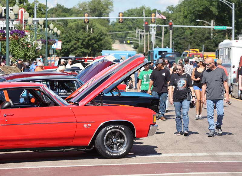 Visitors check out the cars on State Street in Sycamore Sunday, July 31, 2022, during the 22nd Annual Fizz Ehrler Memorial Car Show.