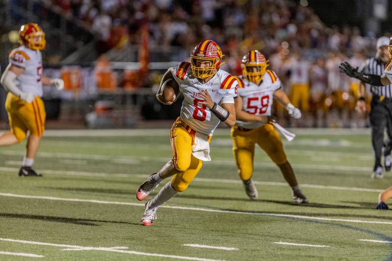 Batavia's Michael Vander Luitgaren looks runs the ball against St. Charles North on Friday, Sept. 26, 2025 in St. Charles.