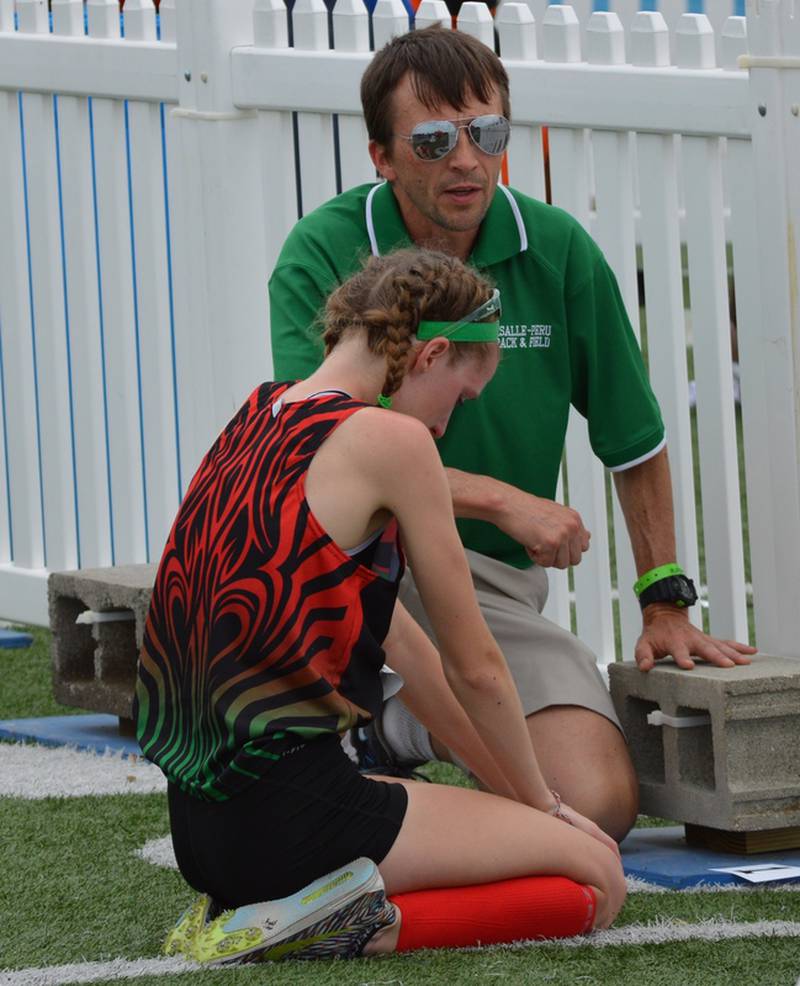 La Salle-Peru girls track and field coach John Beatty talks to Rachel Hickey during the IHSA Class 2A State Track and Field Meet in 2017. Beatty has guided the girls track and field and the boys and girls cross country teams to unprecedented success. This year, the boys cross country team won a regional title and the girls track team won its first sectional title.