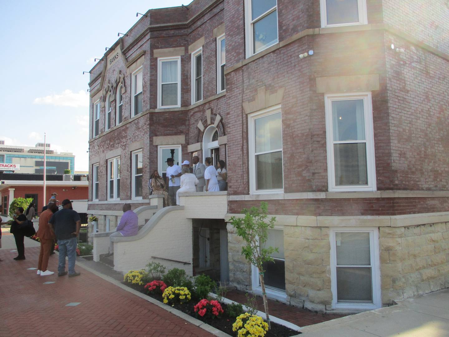 People gather outside the front entrance to The Banks Bridal Suites & Lodging, a bouquet hotel that has opened in downtown Joliet. April 23, 2026