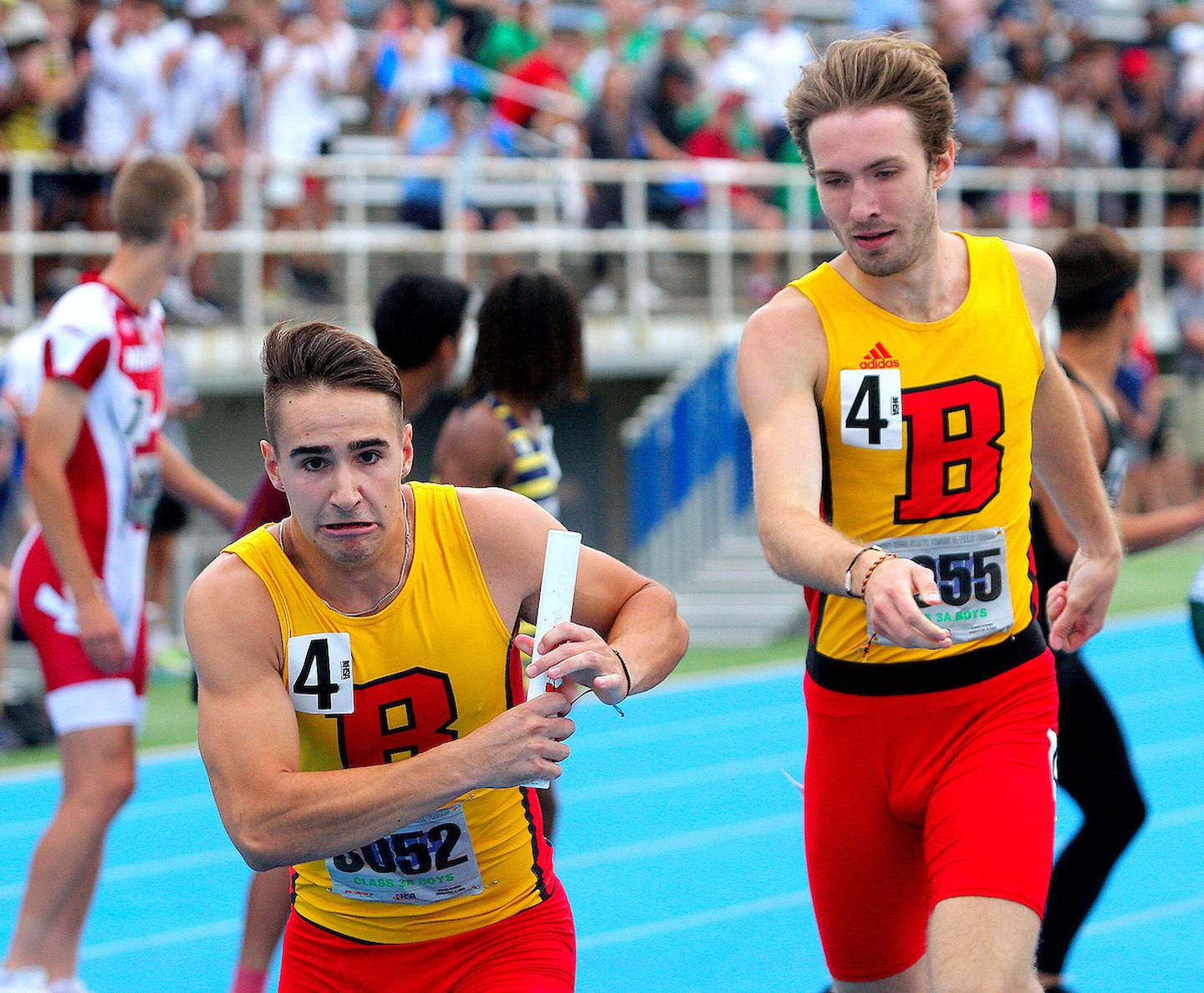 June 19, 2021 - Charleston, Illinois - Anthony Bradley takes the baton from teammate Batavia's Jonah Fallon while running in the Class 3A 4x400-Meter Relay at the Illinois High School Association Track & Field State Finals on Friday