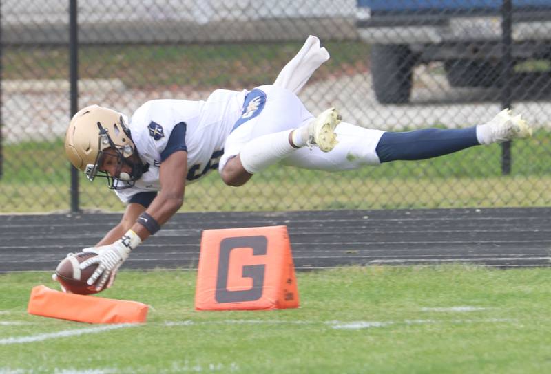 Marquette's Connor Baker dives for the pylon to score the teams only touchdown against Gibson City-Melvin-Sibley during the Class 1A playoff game on Saturday, Nov. 1, 2025 at Gibson City-Melvin-Sibley High School.