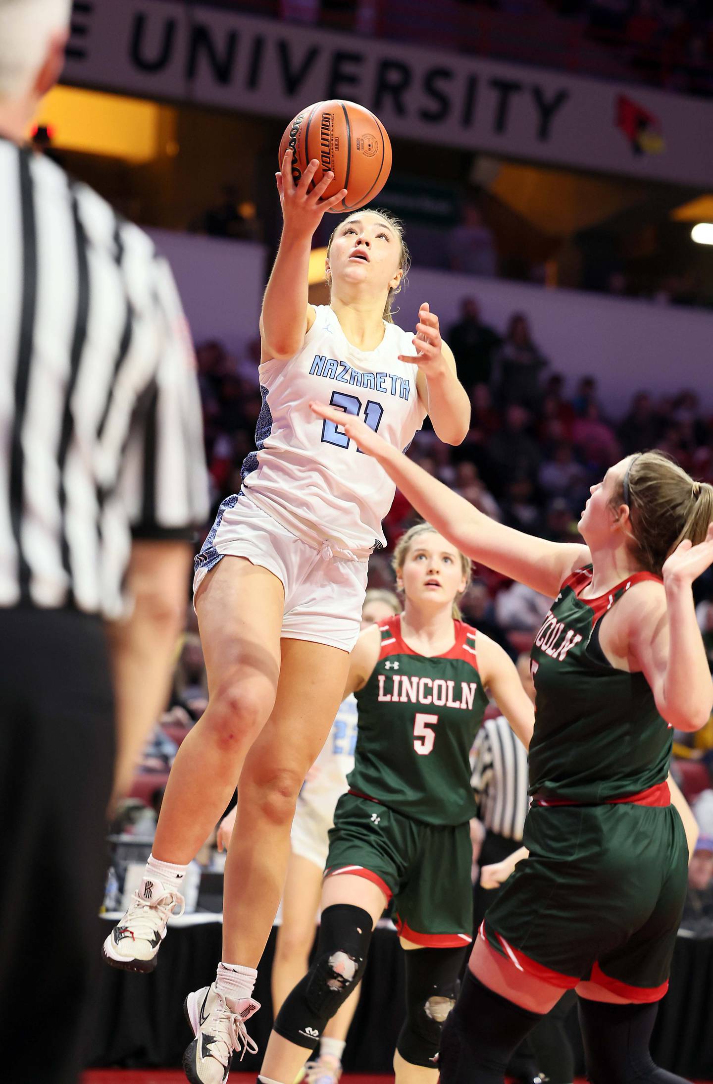Nazareth Academy's Olivia Austin (21) drives to the hoop during the IHSA Class 3A girls basketball championship game at the CEFCU Arena on the campus of Illinois State University Saturday March 4, 2023 in Normal.