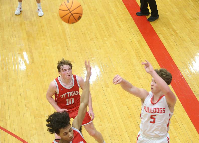 Streator's Isaiah Weibel drains a three point basket over Ottawa's Hezekiah Joachim during the Class 3A Regional semifinal game on Wednesday, Feb. 26, 2025 in Sellett Gymnasium at L-P High School.