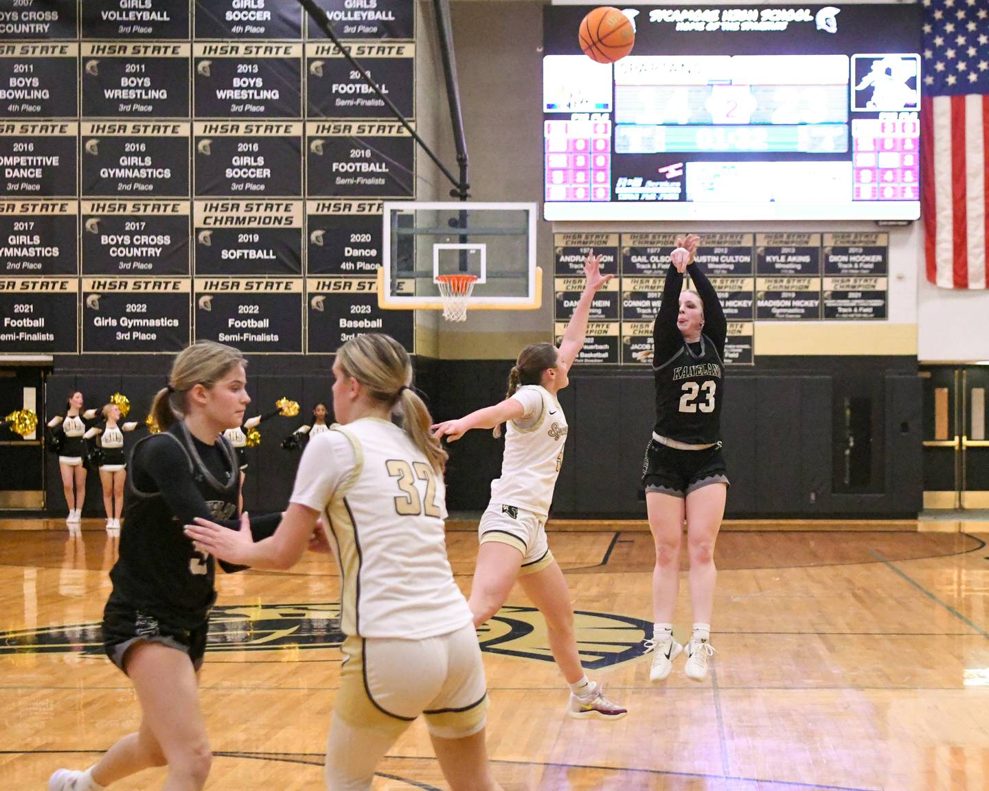 Kaneland's Kendra Brown (23) makes a three-point basket while being defended by Sycamore's Grace Amptmann (5) during the game on Monday Feb. 10, 2025, held at Sycamore High School.