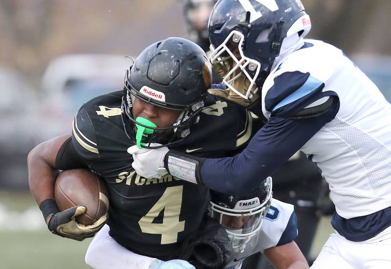 Sycamore's Tyler Curtis  tries to shake off Nazareth's Logan Malachuk Saturday, Nov. 18, 2022, during the state semifinal game at Sycamore High School.