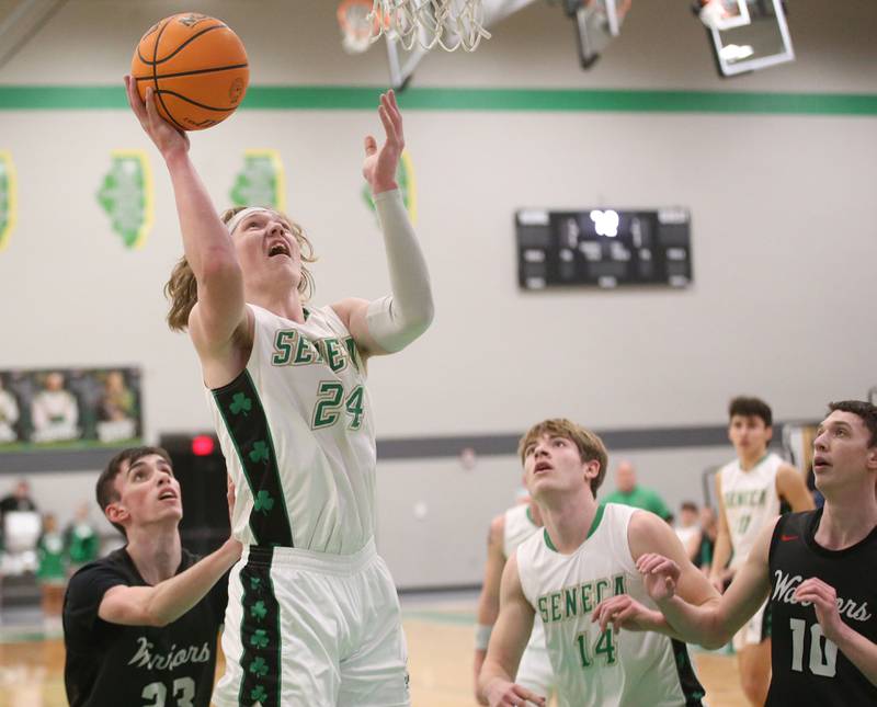 Seneca's Grant Siegel (24) posts up in the lane to score over Woodland's Nick Plesko (23) on Friday, Feb. 14, 2025, at Seneca High School.
