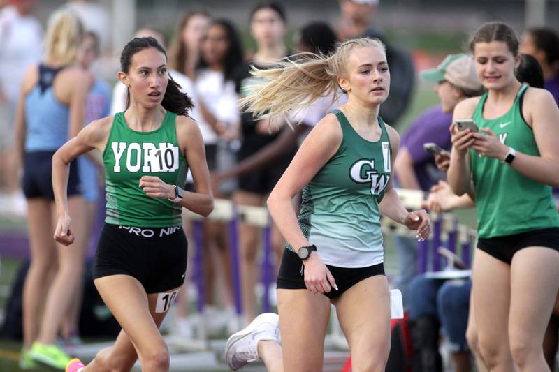 York’s Sophia Galiano-Sanchez and Glenbard West’s Elayna Boeh compete in the 800-meter run during the Ritter Invite girls track and field meet at Downers Grove North on Friday, April 14, 2023.