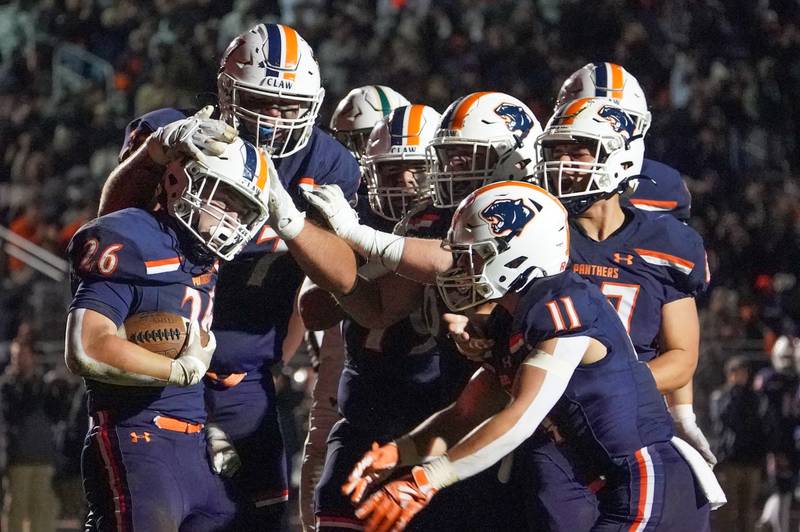 Oswego’s Dekker Zelensek (26) celebrates with his team after scoring a touchdown against Waubonsie Valley during a Class 8A first-round playoff game at Oswego High School on Friday, Nov. 1, 2024.