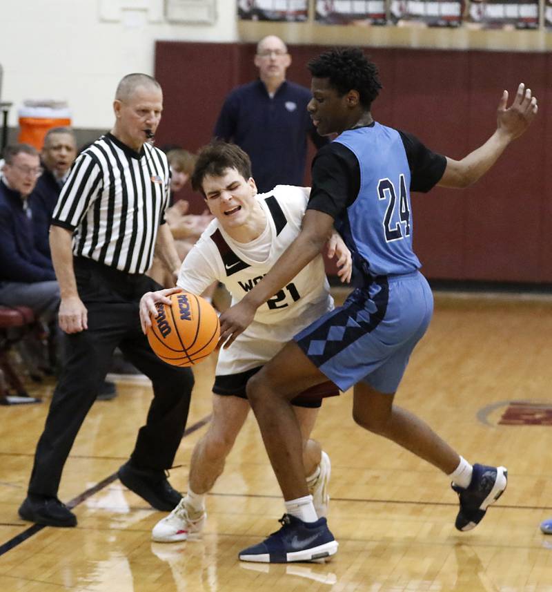 Prairie Ridge's Brendan Beu is foulded by Illinois Math & Science Academy's Omar Njikam as he brings the ball up the court during a IHSA Class 3A Burlington Central Regional quarterfinal boys basketball game on Monday, feb23, 20256, at Prairie Ridge High School in Crystal Lake.