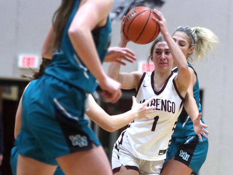 Marengo’s Emily Kirchhoff navigates through heavy traffic against Woodstock North in girls basketball at Marengo on Thursday.