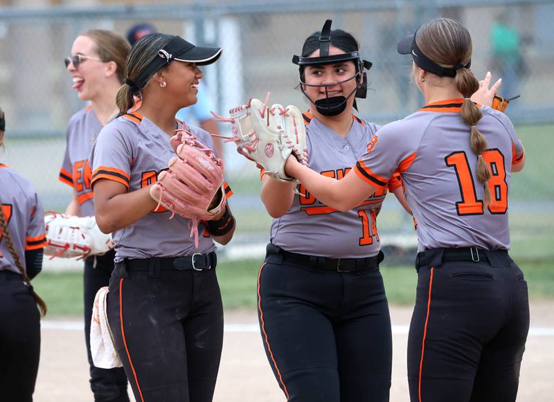 DeKalb infielders celebrate a strikeout by pitcher Jasmine Rodriguez Tuesday, May 19, 2026, during their Class 4A regional game against Harlem at DeKalb High School.
