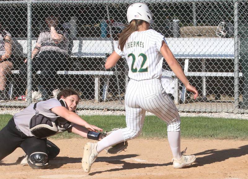 Midwest Central catcher Emma Junkin mises the tag on Ella Hermes at the plate during the Class 2A Regional final on Friday, May 17, 2024 at at Abbot Phillip Davy Field.
