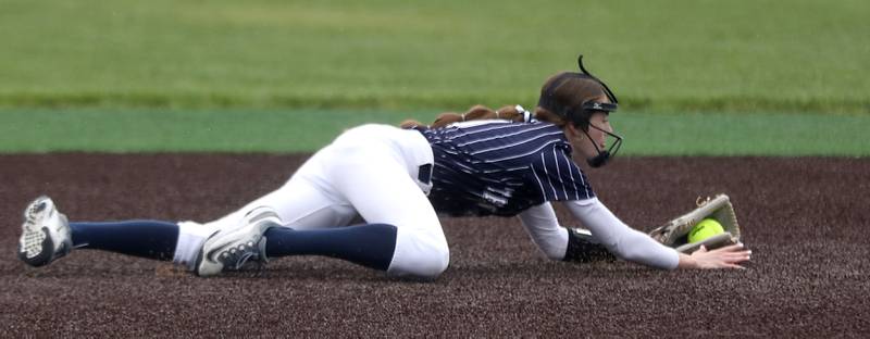 Cary-Grove's Ella Grimm makes a diving stop during a Fox Valley Conference softball game against McHenry on Thursday, April 30, 2026, at McHenry High School.