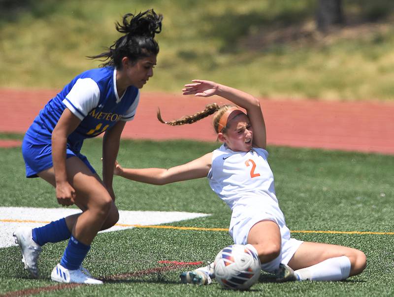 Crystal Lake Central’s Kalissa Kaiser falls while battling De La Salle’s Sophia Torres in the IHSA girls Class 2A third-place soccer game at North Central College in Naperville on Saturday, June 3, 2023.