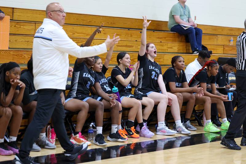Kankakee players celebrate a three-pointer by Malea Harrison during the Kays' 75-28 victory over Rosary at the Reed-Custer Classic on Monday, Nov. 17, 2025.