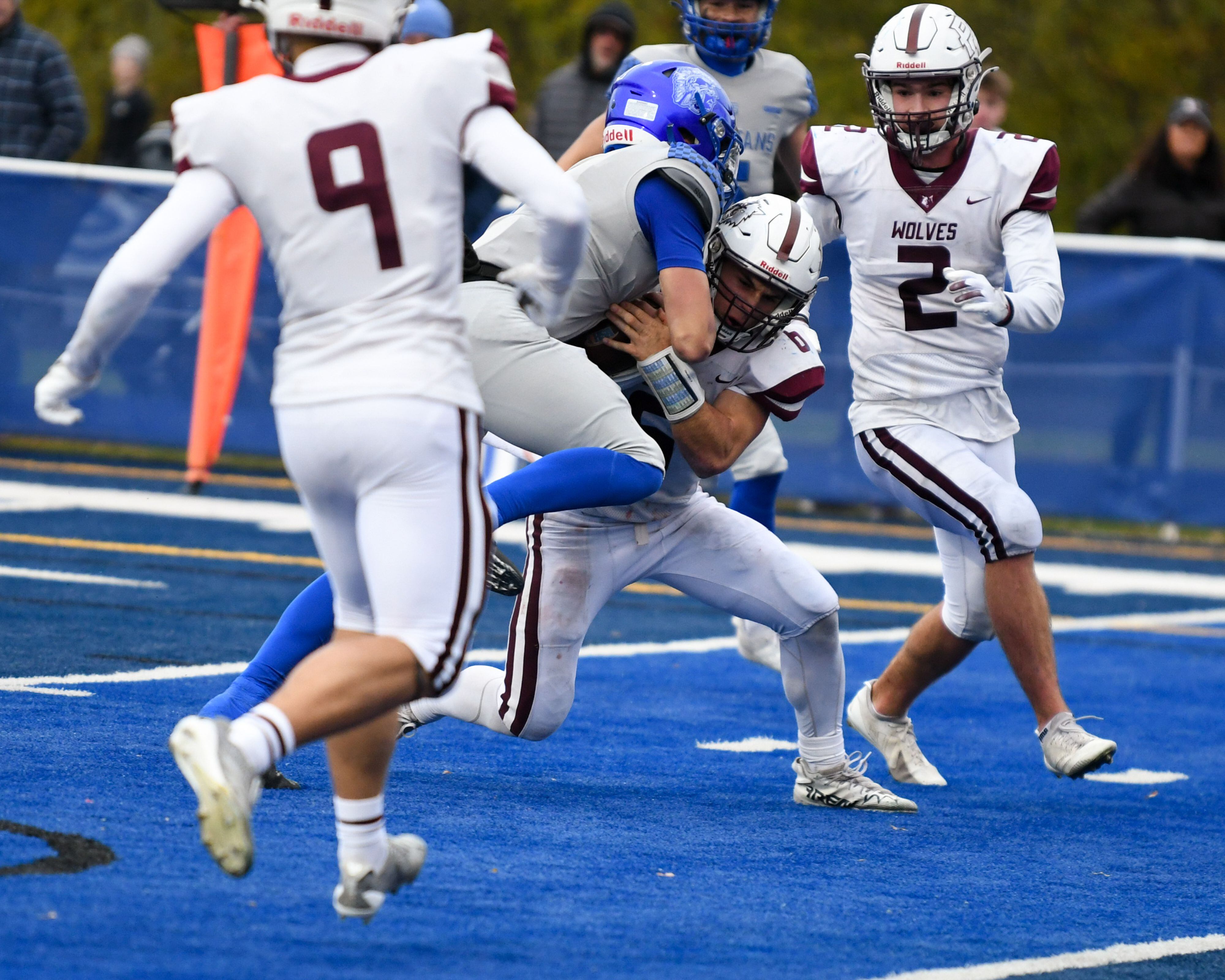 St. Francis's Brock Phillip, center, gets into the endzone while being defended by Prairie Ridge's Luke Vanderwiel (6) during the second round of the 5A playoff game on Saturday Nov. 8, 2025, held at St. Francis's High School.