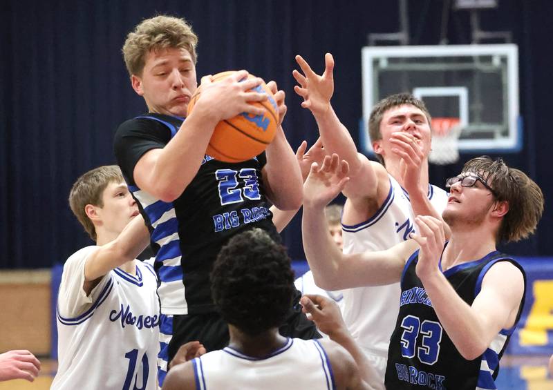 Hinckley-Big Rock's Luke Badal grabs a rebound surrounded by three Newark defenders Friday, Feb. 6, 2026, during their Little 10 Conference third place game at Somonauk High School.
