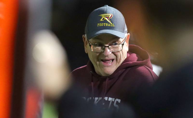 Richmond-Burton’s Head Coach Mike Noll guides the Rockets as they build a first-half lead in IHSA football Class 3A second-round playoff action at Bob Stewart Field on the campus of Aurora Central Catholic High School in Aurora on Friday, November 7, 2025.