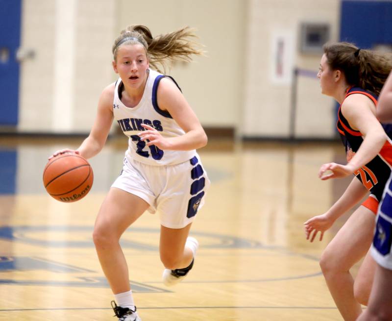 Geneva’s Caroline Madden (20) drives toward the basket during a home game against Naperville North on Tuesday, Nov. 29, 2022.