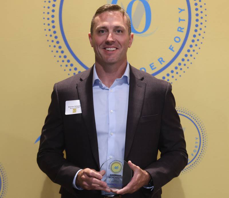 Brandon Scheppers poses with his 40 Under Forty award during the Illinois Valley Chamber of Commerce Champions of Change Awards Night on Wednesday, May 6, 2026 at the Westclox Event Center in Peru.