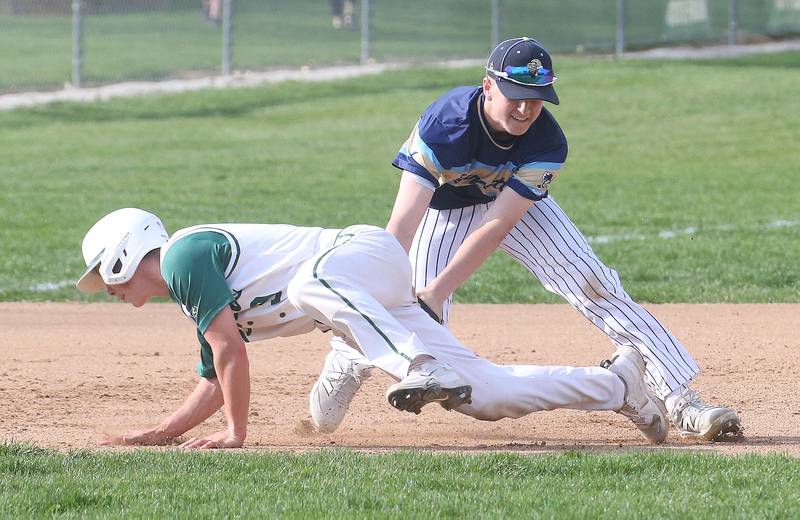 St. Bede's Geno Dinges is tagged out in a run down between second and third base by Marquette's Caden Durdan on Thursday, April 24, 2025 at St. Bede Academy.