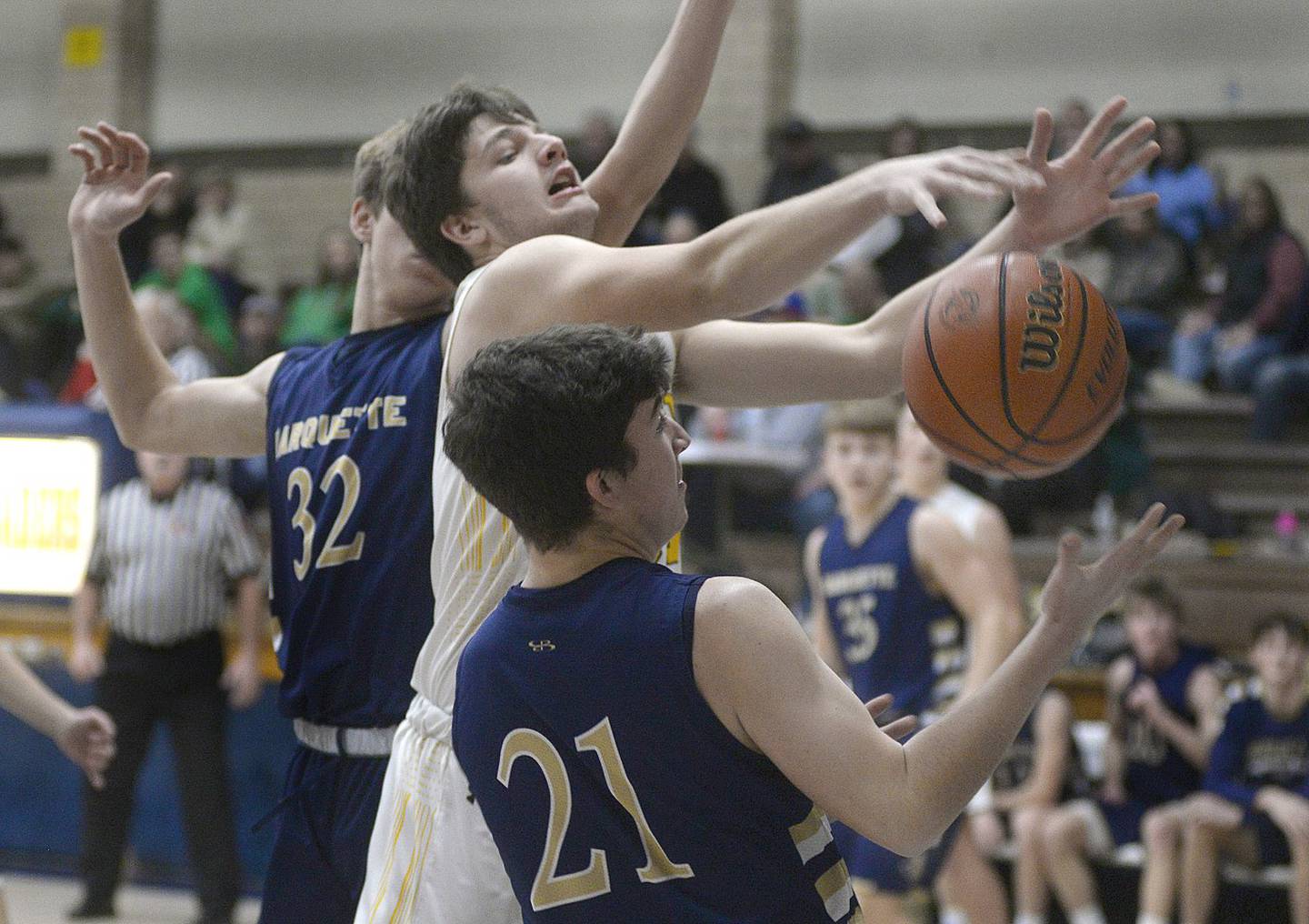 Reed Custer’s Cooper Smith tangles with Marquette’s Carson Zellers for a rebound in the opening period of Wednesday's semifinal of the Marquette Christmas Tournament at Bader Gym in Ottawa. - 12/28/22