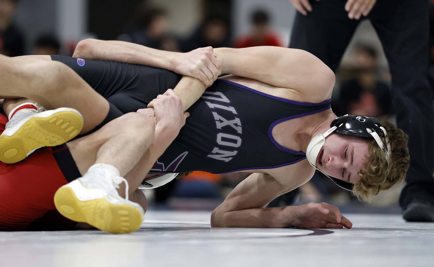 Kai Enos of Batavia wrestles Jack Ragan of Dixon at 120-pounds during the semi-final round of the 65th Mudge-McMorrow Wrestling Invite Saturday, Dec. 13, 2025 in Mount Prospect.