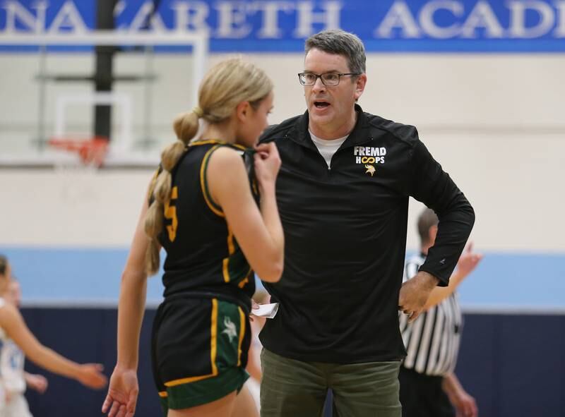 Fremd's coach Dave Yates talks to Ellie Thompson during the girls varsity basketball game between Fremd and Nazareth on Monday, Jan. 9, 2023 in La Grange Park, IL.