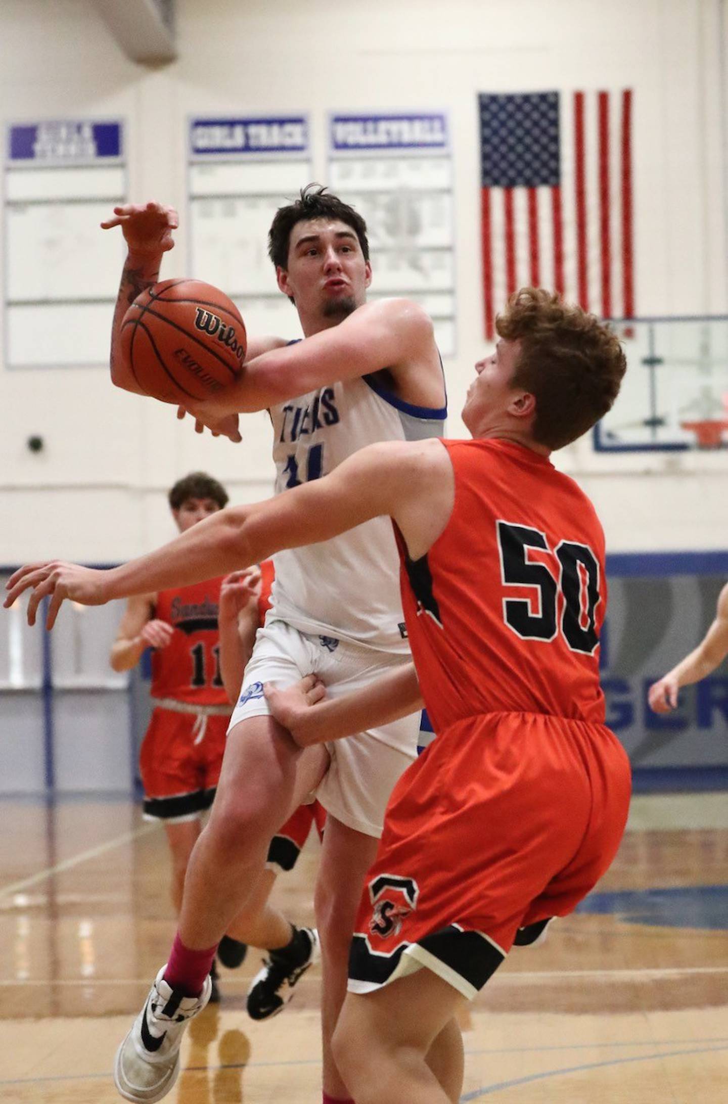 Sandwich's Quinton Rome bats a ball away from Princeton's Kolten Monroe Tuesday at Prouty Gym. The Tigers won 60-43.