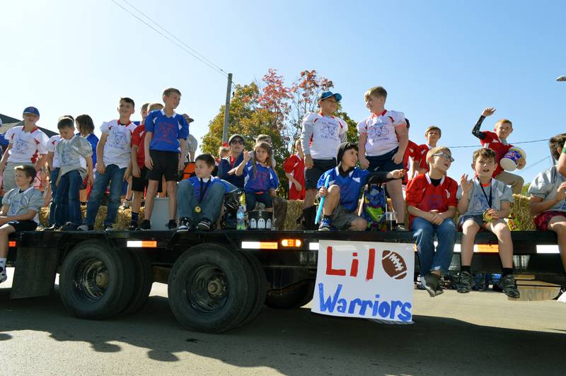 Members of the Lil Warriors Flag Football team out of Stillman Valley ride in the Harvest Time Parade on Sunday, Oct. 6, 2024, during the 53rd annual Autumn on Parade in Oregon.