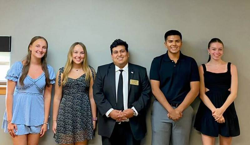 Local high school graduates Alijca Noga, Abigail Young, Adrian Zamudio, and Leah Muska stand with Lockport Township Supervisor Alex Zapien after receiving their scholarship awards.