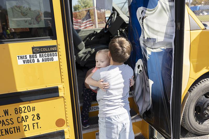 Nathan Payne, 7, helps little sister Sophia, 2, off of the haunted school bus Saturday, Oct. 22, 2022 at First Student transportation’s Halloween fun fest.