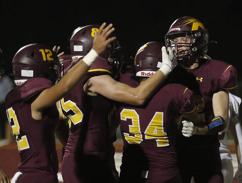 Richmond-Burton's Toby Quentrall-Quezada, No. 34, celebrates with his teammates after score a touchdown during a Kishwaukee River Conference / Interstate 8 Conference crossover football game Friday, Sept. 30, 2022, between Richmond-Burton and Morris at Richmond-Burton Community High School in Richmond.