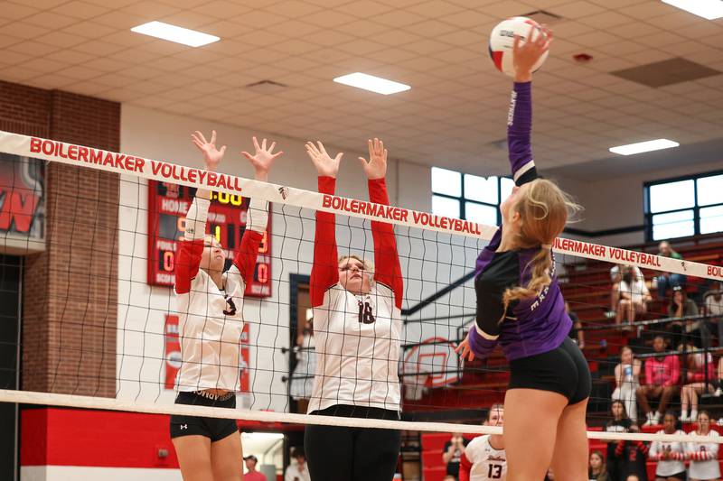 Bradley-Bourbonnais' Samantha Harsy, left, and Elena Shold jump to block a hit by Manteno's Maddy Belisle during the Panthers' victory in three sets, 25-21, 23-25, 25-17, over the Boilermakers on Monday, Sept. 15, 2025.