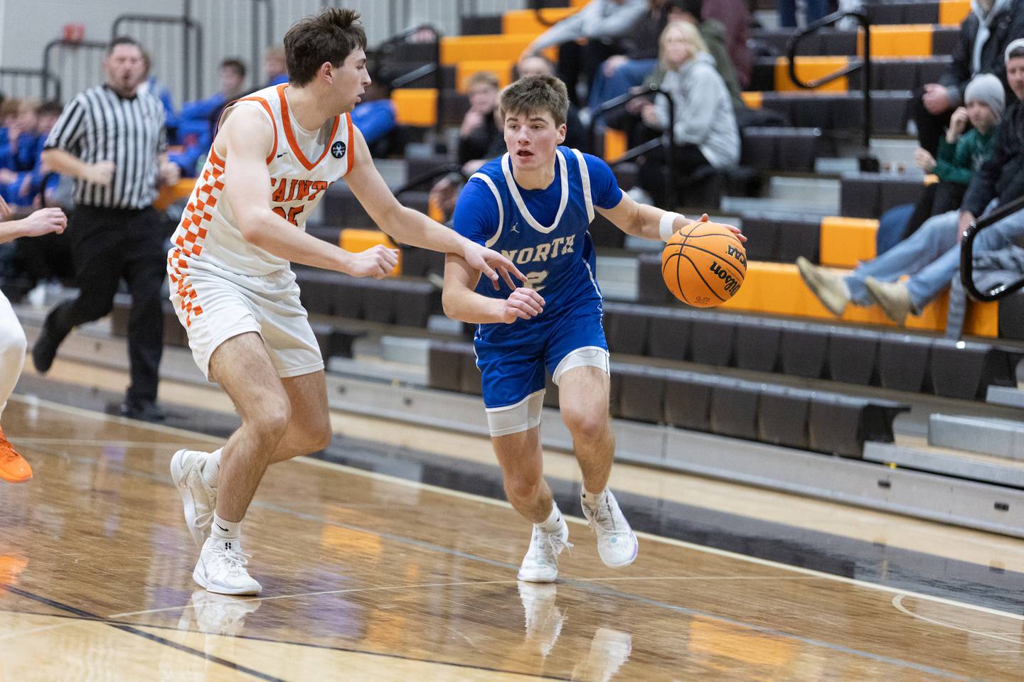 Wheaton North's Briggs Barnick looks to drive the baseline against St. Charles East's Gavin Belli on Saturday, Dec.13,2025 in St. Charles.