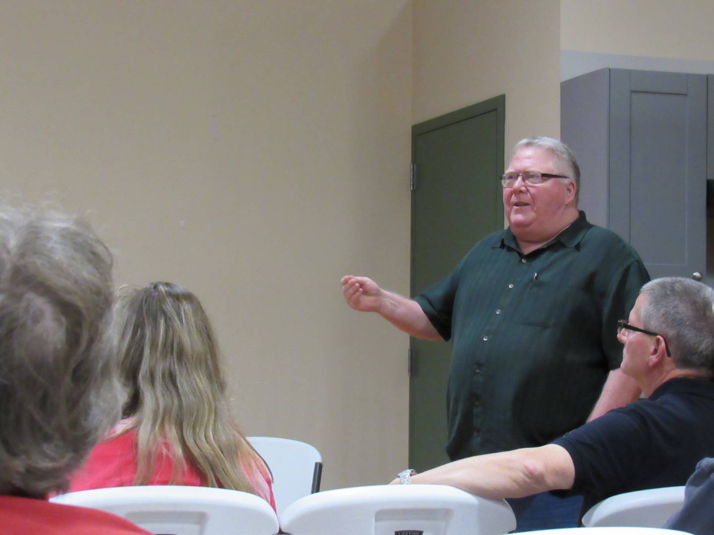 Jeff Poundstone explains to a crowd the difficulty in finding information about Paul Carter, a Grundy County Gold Star veteran that there isn't much information left about.