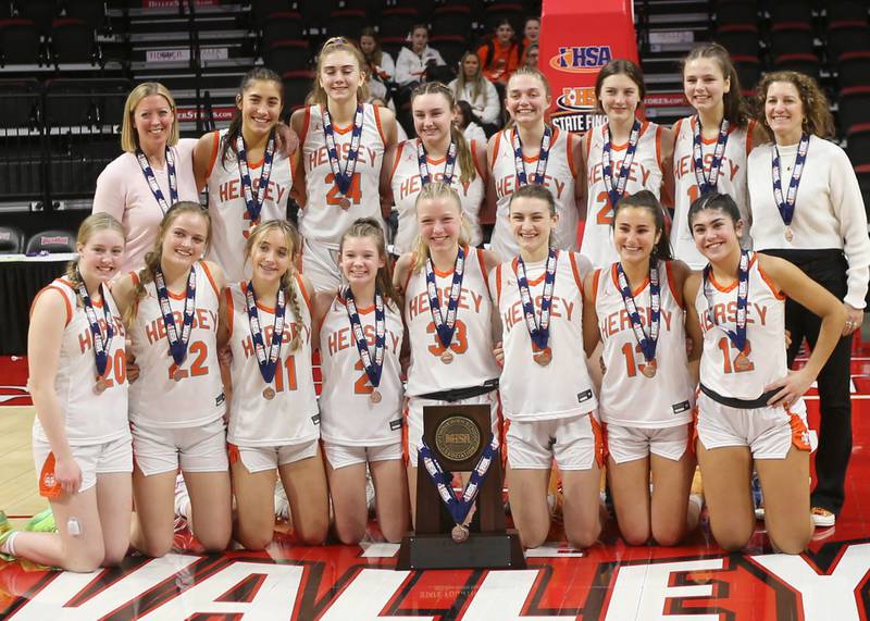 Members of the Hersey girls basketball team pose with their Class 4A State trophy after loosing to Geneva during the third place game on Friday, March 3, 2023 at CEFCU Arena in Normal.