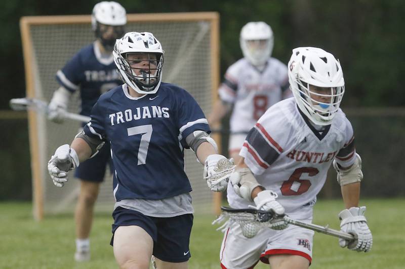 Cary-Grove's Michael Dunkin chases Huntley's Michael Boniak as Boniak runs with the ball during the Marian Central Sectional boys lacrosse semifinal match on Wednesday, May 28, 2025, at Marian Central High School in Woodstock.