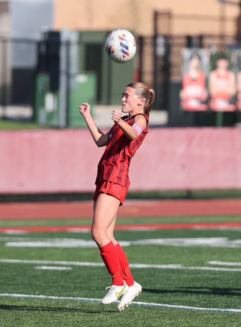 Hinsdale Central's Carter Knotts heads the ball during the girls varsity soccer match between Lyons Township and Hinsdale Central high schools in Hinsdale on Tuesday, April 18, 2023.