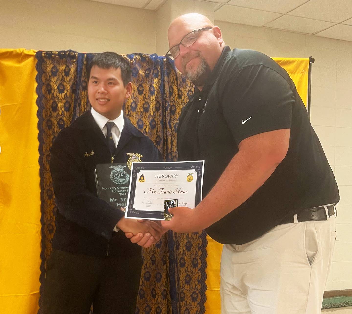 Forreston FFA Officer Josiah Newill presents. Travis Heinz (FJSHS principal) with his Honorary Chapter FFA Degree.