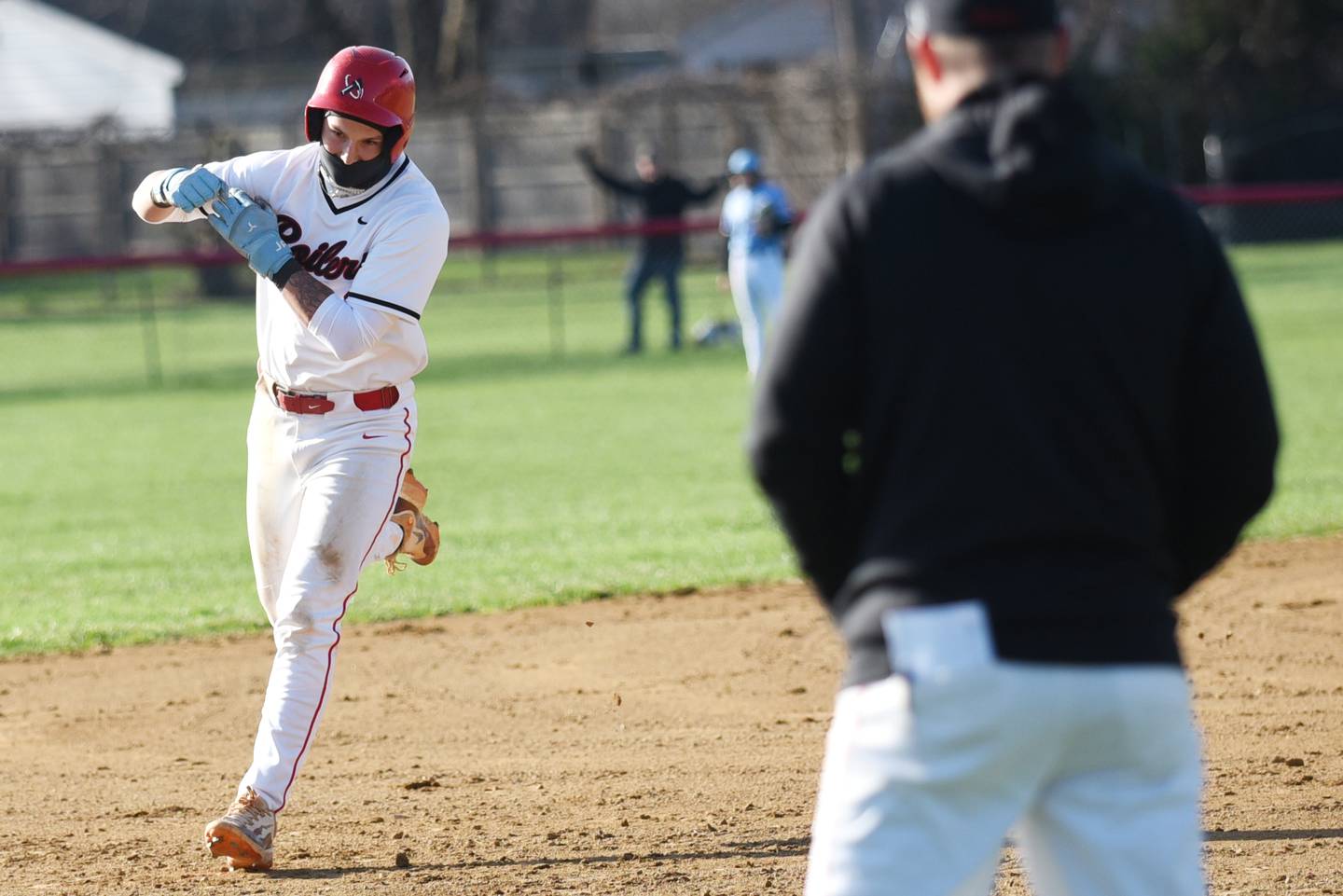 Bradley-Bourbonnais' Cody Freitas, left, flexes as he rounds the bases and approached head coach Brad Schweigert following his home run during a home game against Kankakee Monday, March 31, 2025.