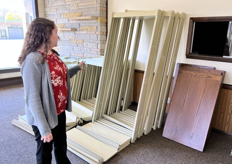 Rylie Roubal, Hinckley Public Library District director, points out some of the shelves Thursday, April 27, 2023, that were donated in the new building they hope to renovate and move the into pending a second round of federal funding. The project has received $750,000 in government funding and is seeking to another $1,064,000.