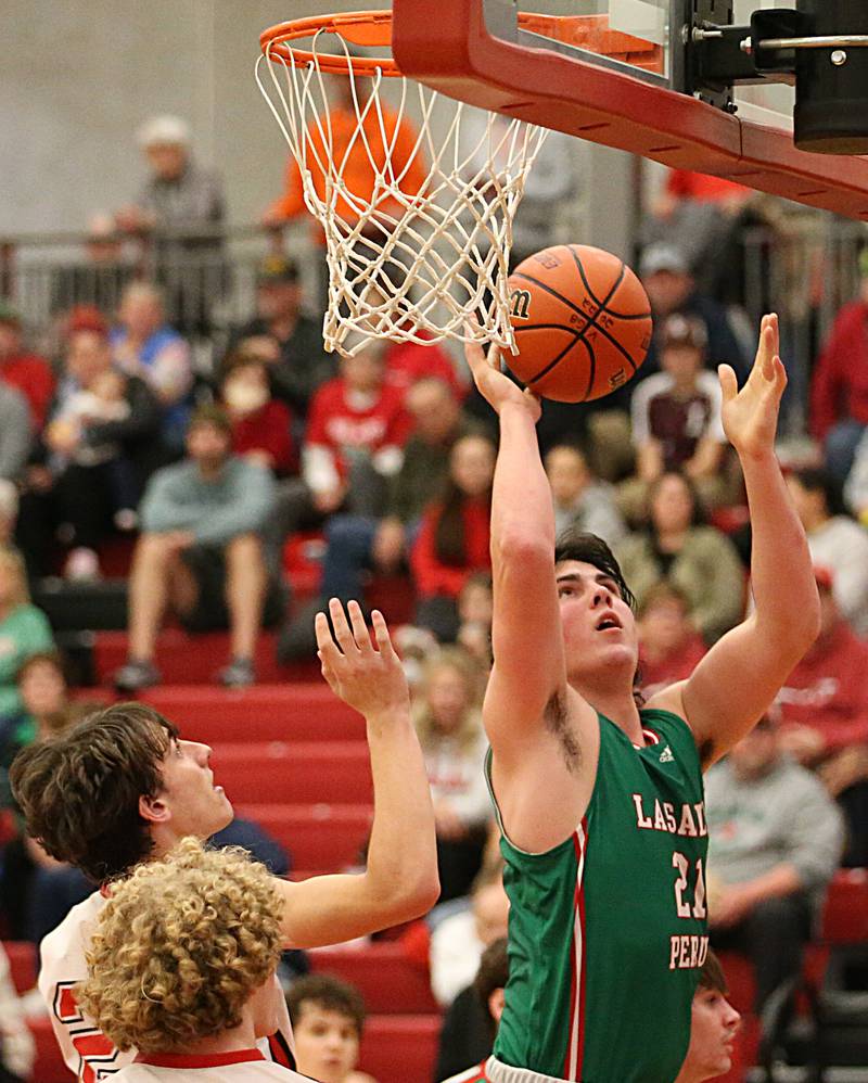 L-P'a Josh Senica (21) scores on a layup past Hall's Kyian Smith (24) and Mac Resetich (0) on Tuesday, Nov. 29, 2022 at Hall High School in Spring Valley.