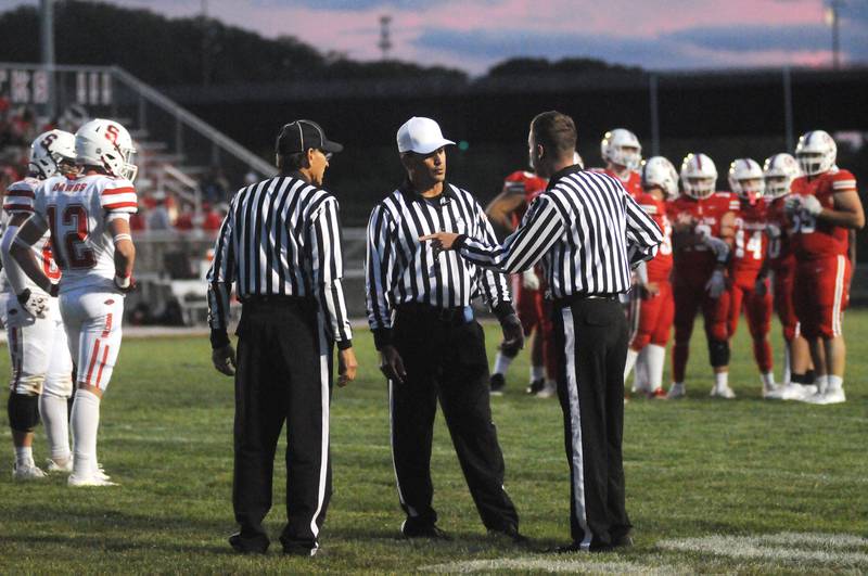 Officials discuss offsetting unsportsmanlike conduct penalties for Streator and Ottawa on Friday, Sept. 5, 2025 at King Field.