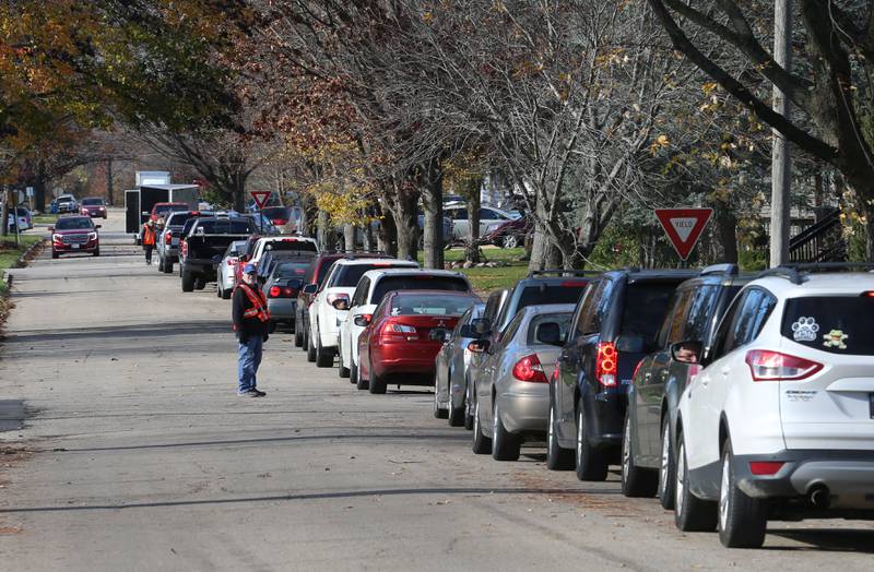 A long line of vehicles stretches over three-blocks long for the annual Thanksgiving distribution on Wednesday, Nov. 20, 2024 at the Hall Township Food Pantry in Spring Valley.